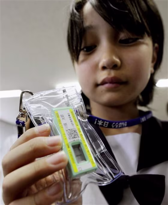 A student in Kawamata town, Fukushima prefecture, holds a radiation meter donated by a local university on June 21, 2011. Radiation meters will be distributed to about 34,000 children living in the largest city of Fukushima in September, a city official said Tuesday.